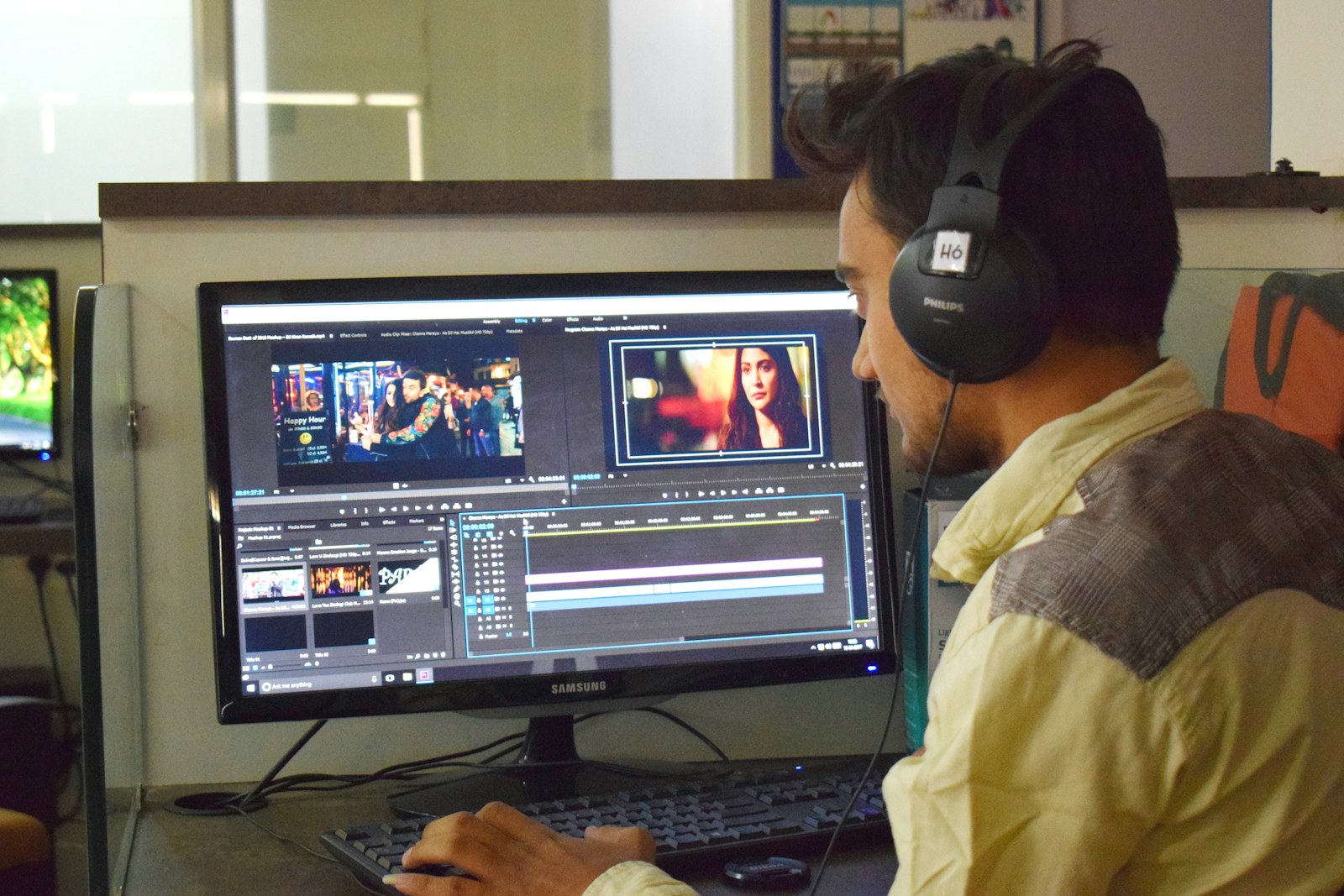 Viewer watching entertainment content on a computer with headphones